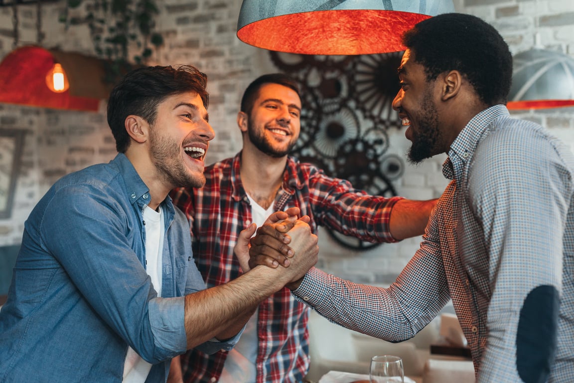 Old friends meeting. Three friends meet in pub